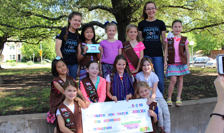 Brownie Troop 8274 presenting a donation check to Paper for Water